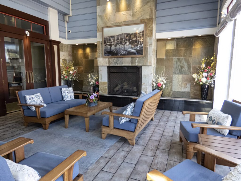 A living area with blue couches and a fireplace