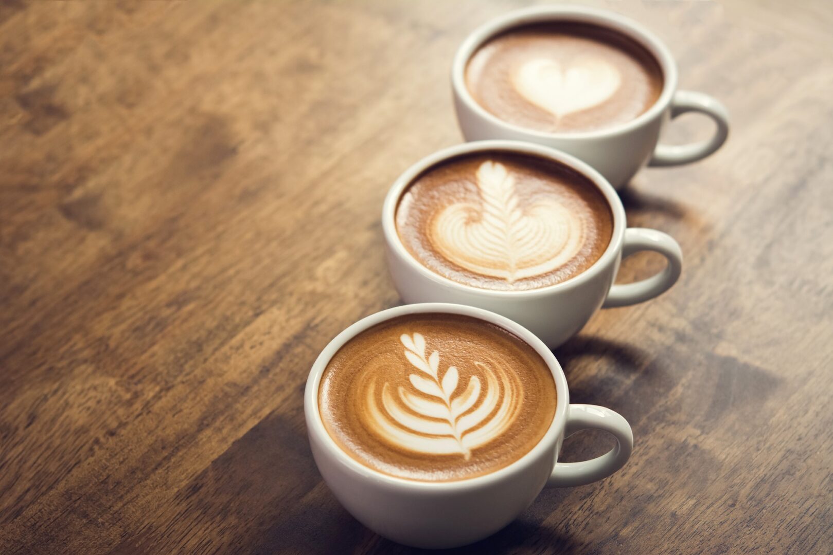 Three cups of coffee with latte art