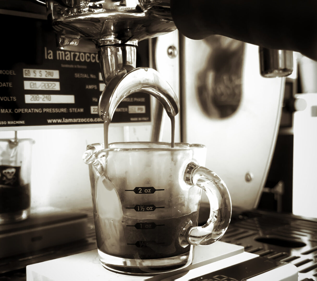 A person is pouring coffee into a cup.